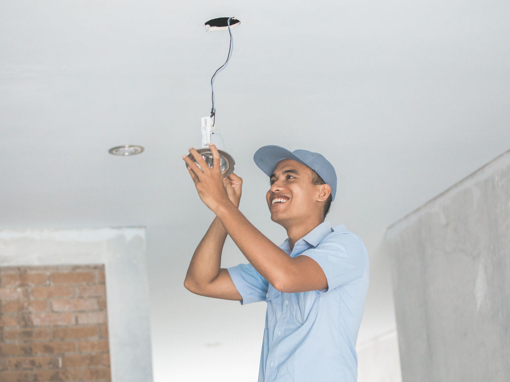 Electrician wiring a ceiling light